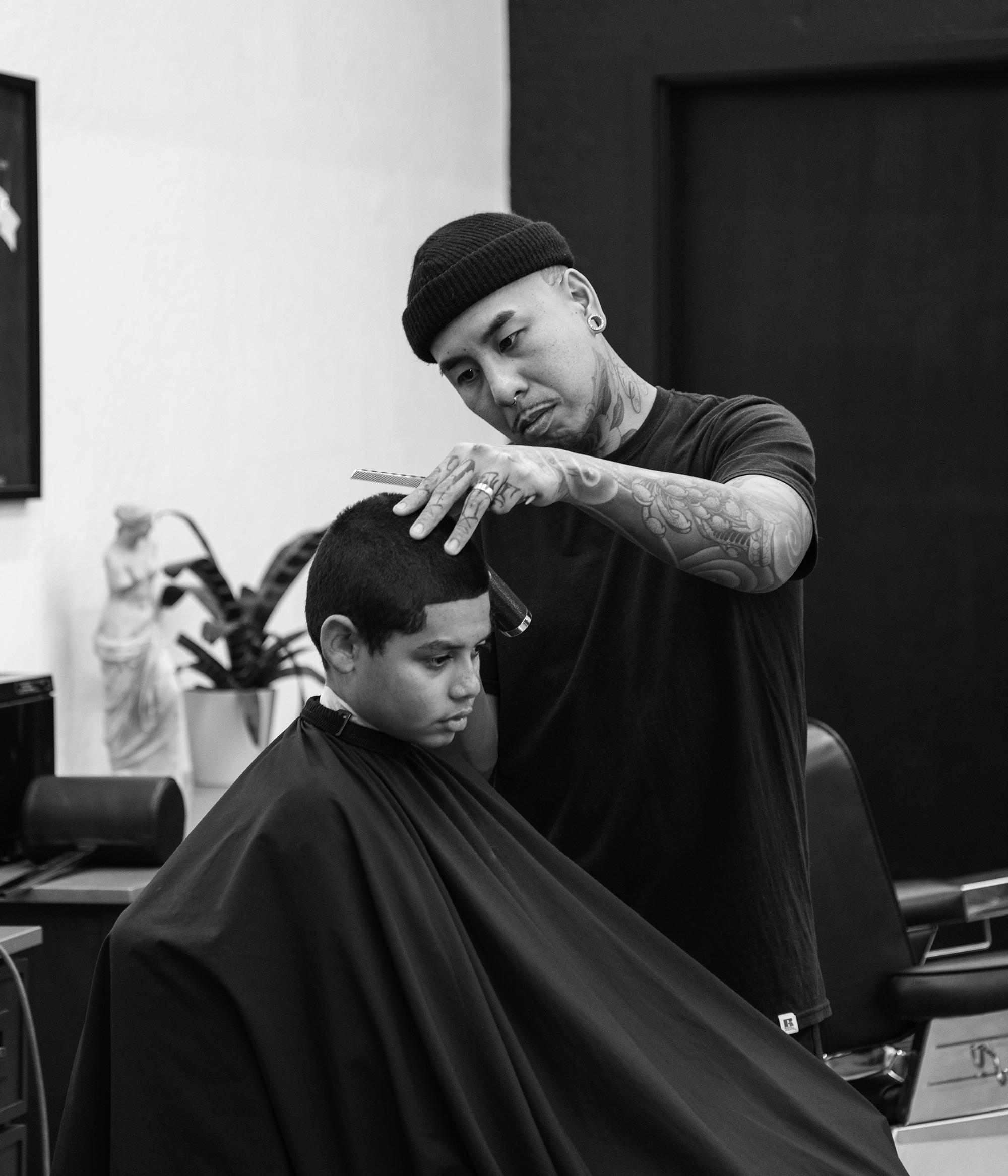 A barber and his client during a hair cut service at Rich in Flesh in Livermore CA